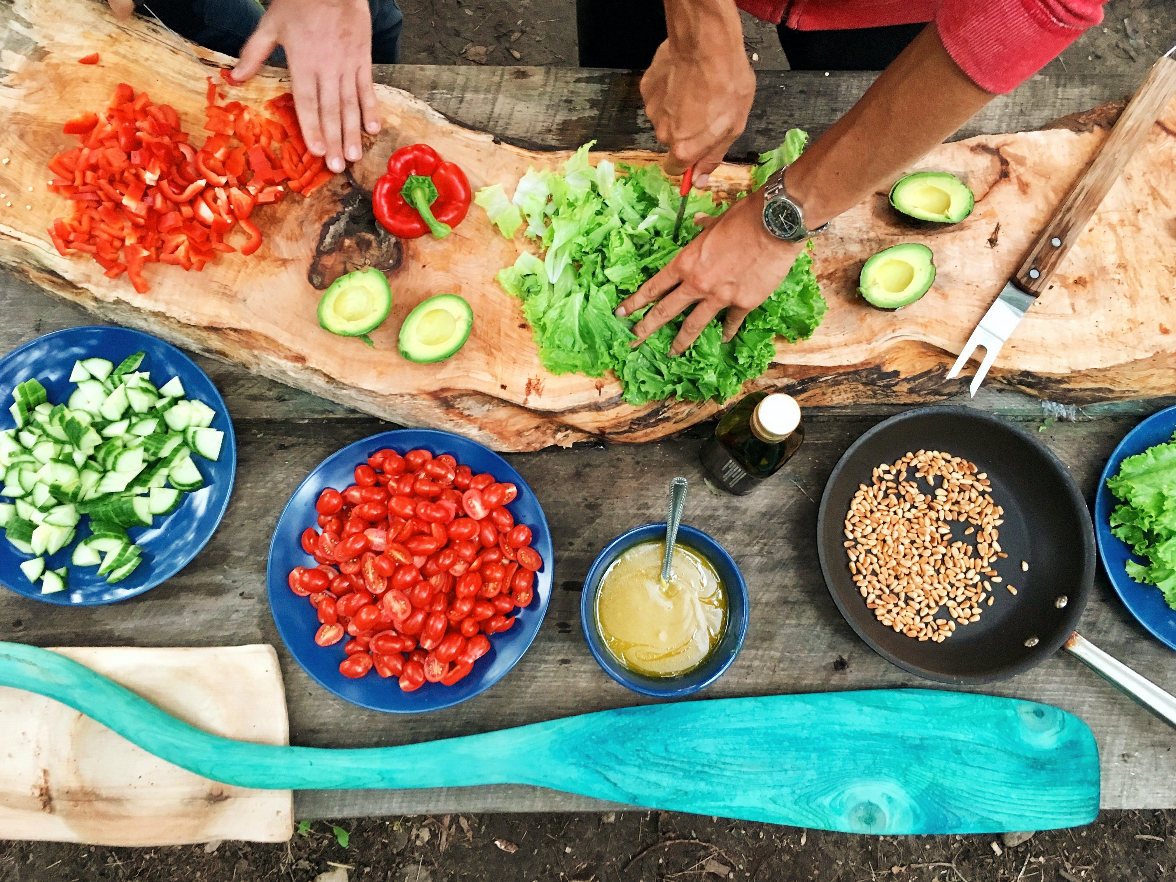 Hands preparing fresh vegetables together for a shared meal